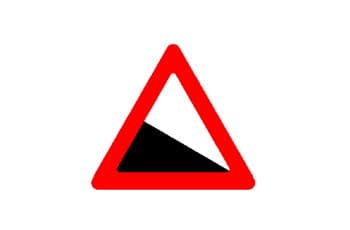 תמרור אזהרה משולש עם מסגרת אדומה. במרכז התמרור ישנו איור של משטח שחור משופע, היורד משמאל לימין.