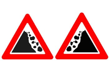 תמרור אזהרה משולש עם מסגרת אדומה, שבתוכו איור של צוק בצד שמאל שממנו מתדרדרות אבנים.